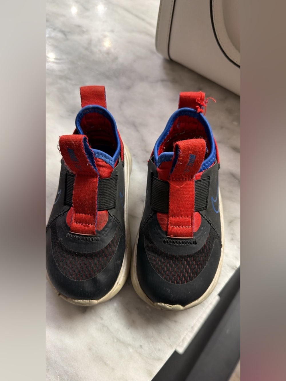 Nike Kids Black and Red Slip-On Sneakers with Blue Trim